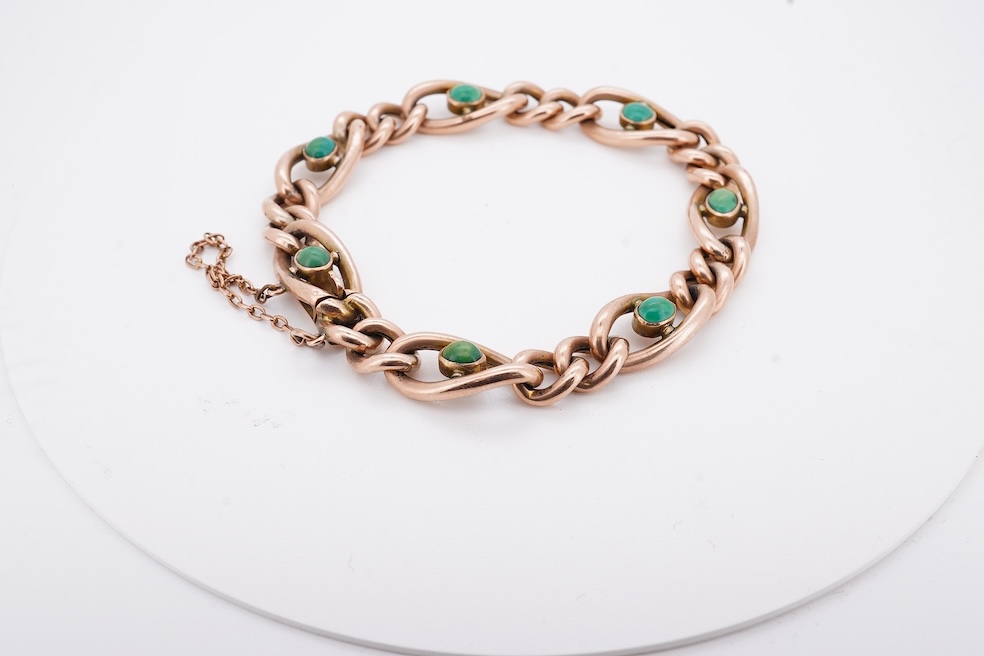 An early 20th century yellow metal (stamped 9c) and seven stone cabochon turquoise set curb link bracelet, 19cm, gross weight 14 grams. Condition - poor to fair